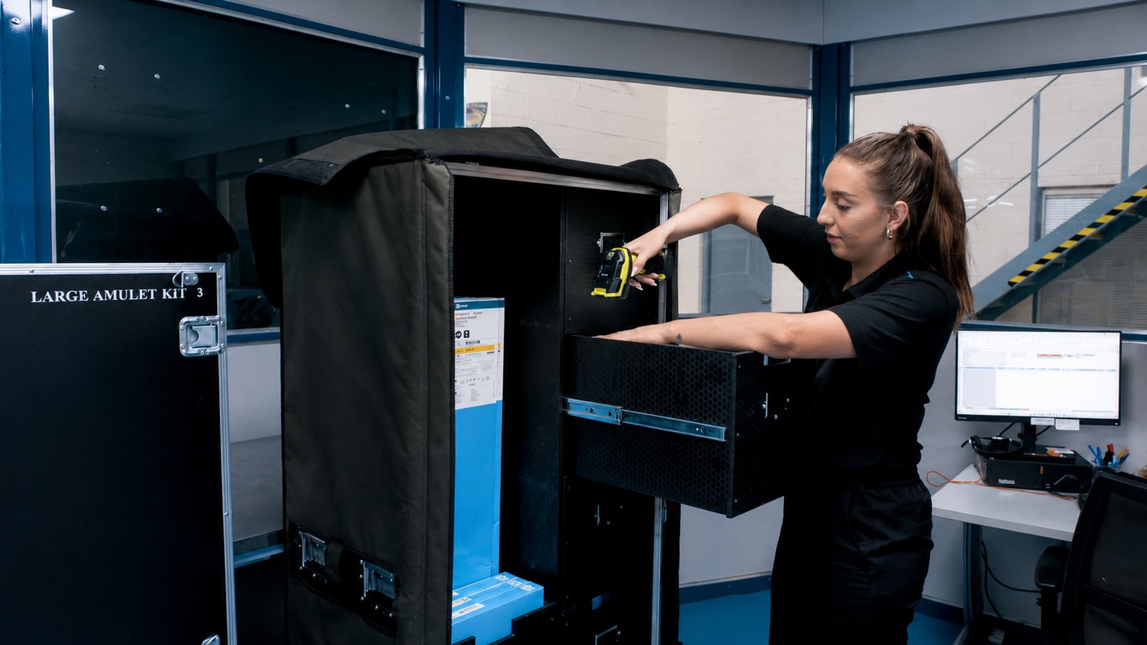 A team member scanning an implant kit in the Swords healthcare operation